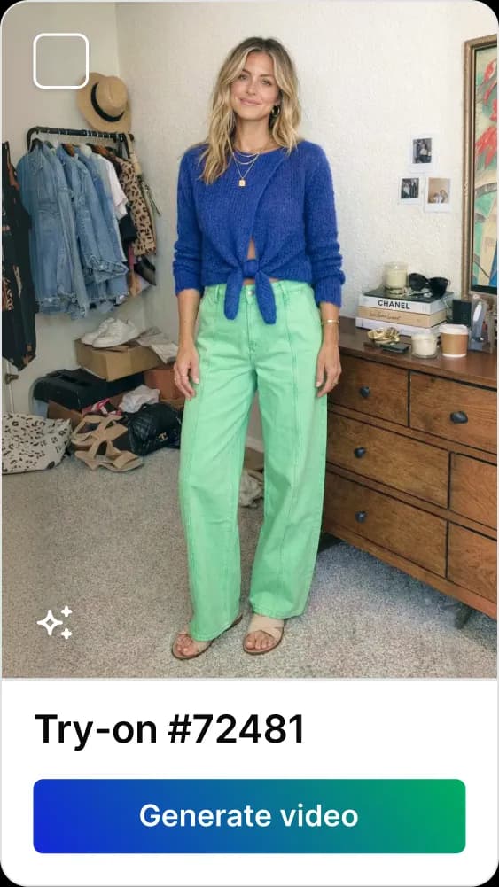 Woman with blonde hair wearing a blue sweater and green pants standing in a bedroom.