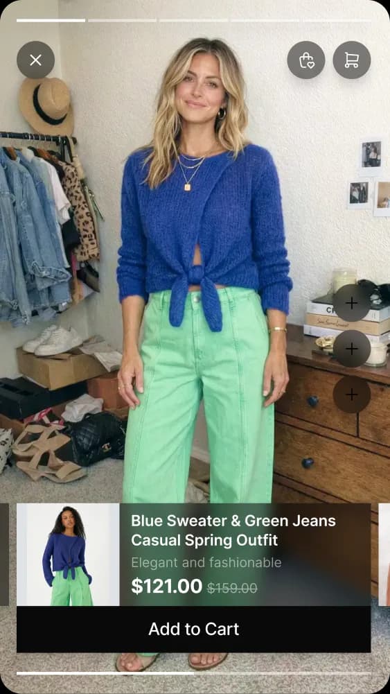 Woman wearing a blue sweater tied at the waist with light green high-waisted jeans in a casual room.